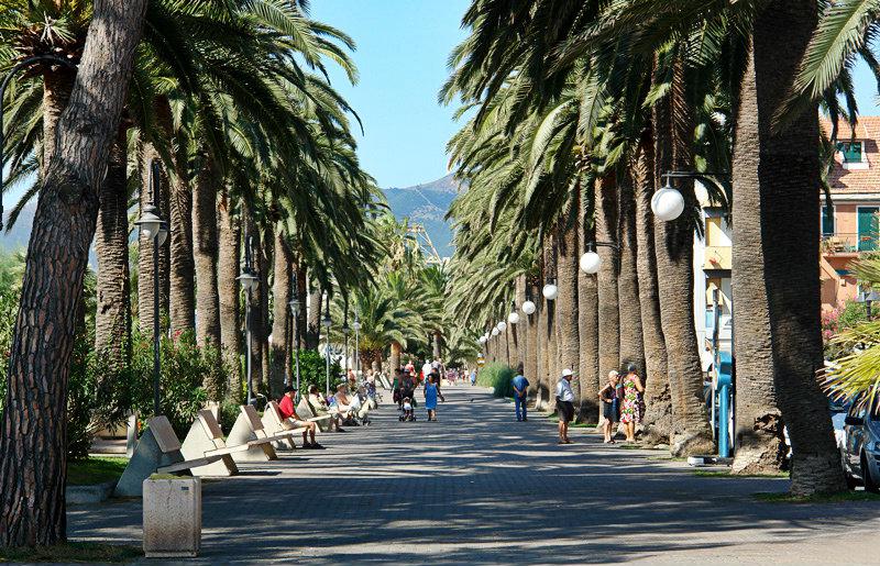 Une rue avec des palmiers Ã  Pietra Ligure