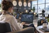 Une voyageuse utilise des horloges mondiales sur son téléphone et son ordinateur dans un salon d’aéroport.